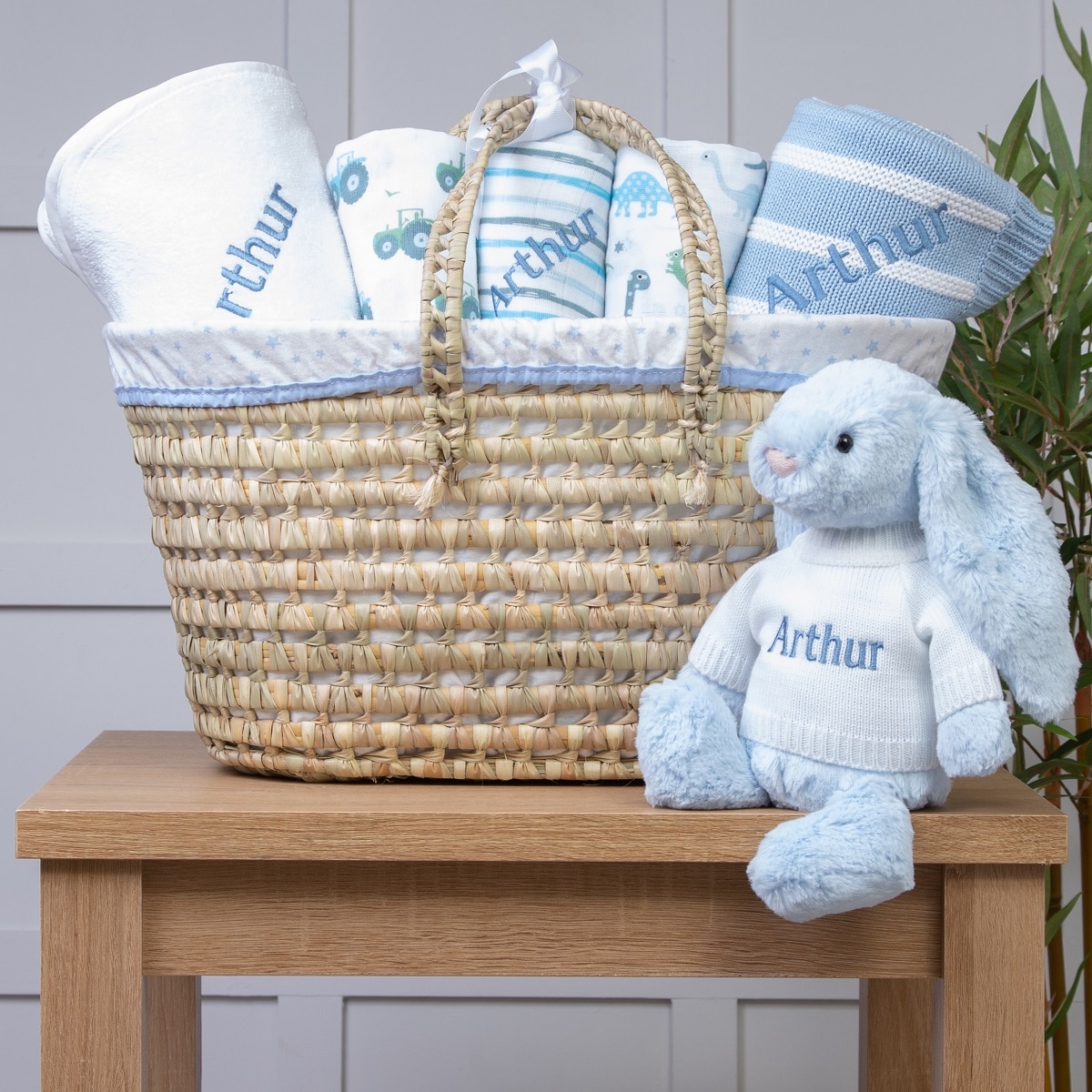 Personalised white and blue baby gift basket with blue bunny soft toy
