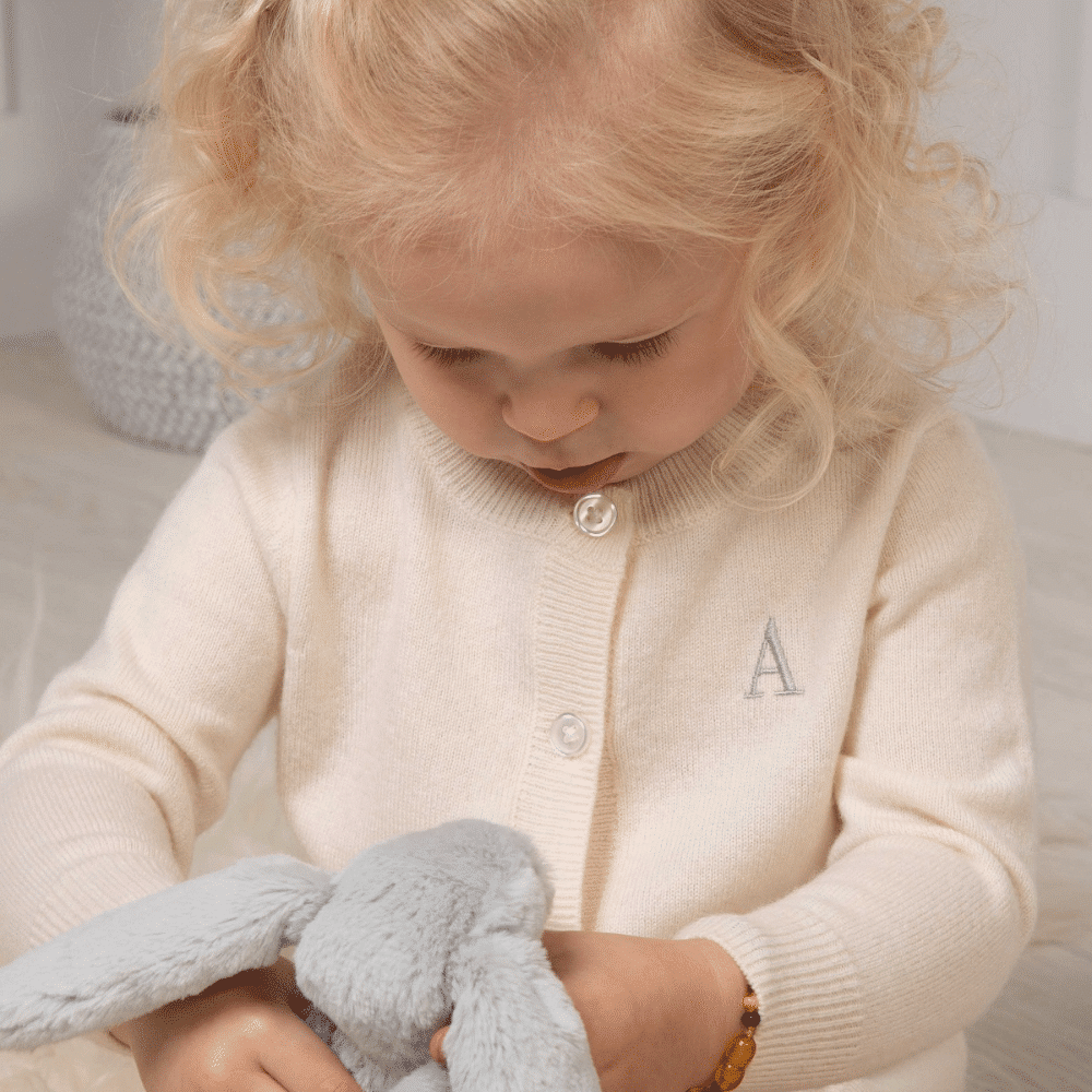 baby playing with bunny teddy