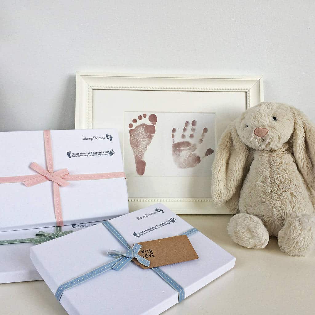 baby foot and hand print with gift box and bunny teddy