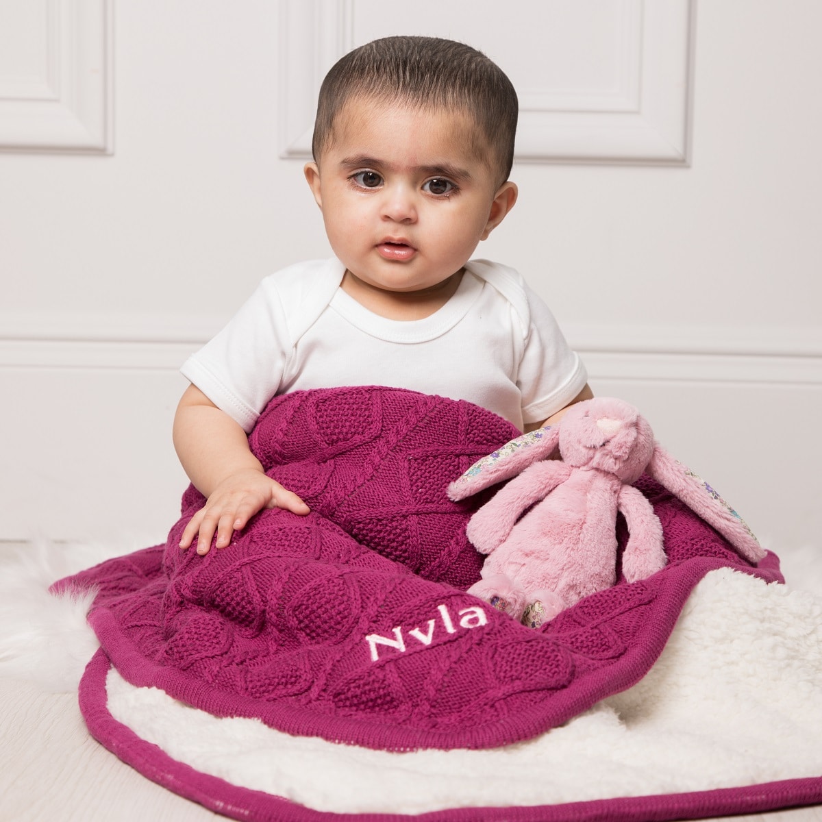 baby with personalised blanket and floral bunny teddy