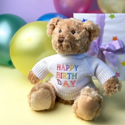 Keeleco recycled small Dougie gift bear soft toy with ‘HAPPY BIRTHDAY’ jumper in Capital letters