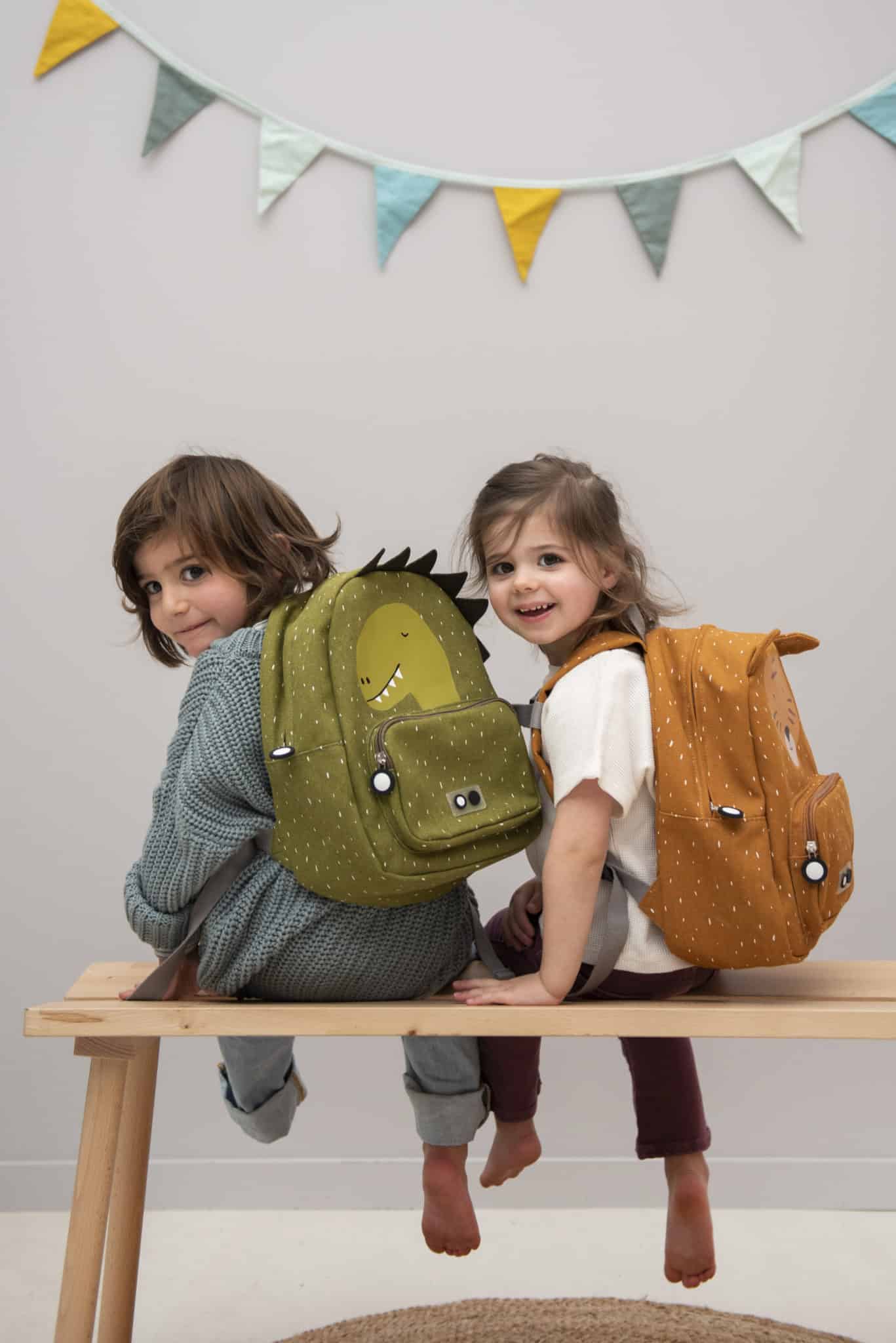 Children Wearing Dinosaur And Tiger Backpack Looking Back