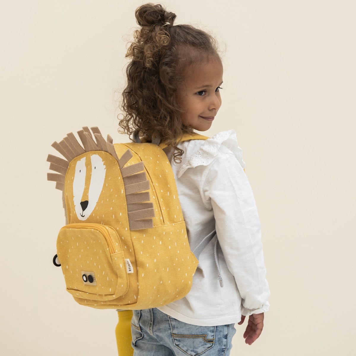 child wearing lion backpack side