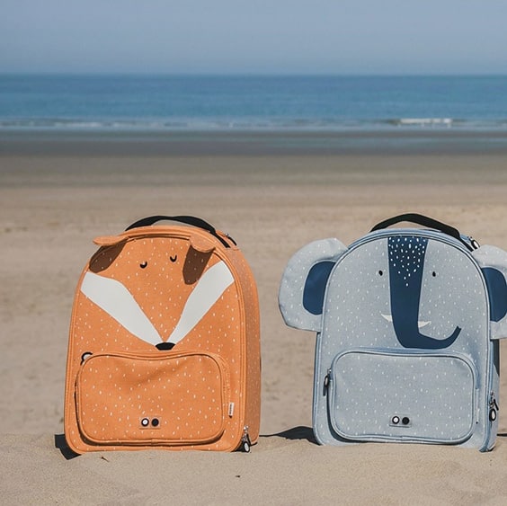 fox and elephant backpacks on the beach