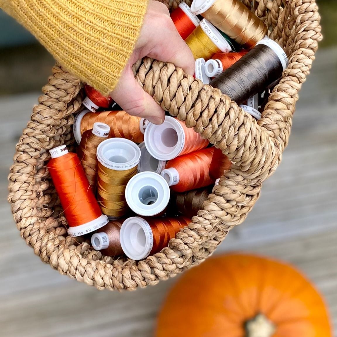 woman carrying sewing threads in a basket